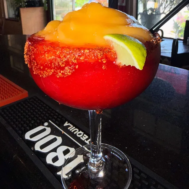 A frozen strawberry-mango margarita with a chile rim