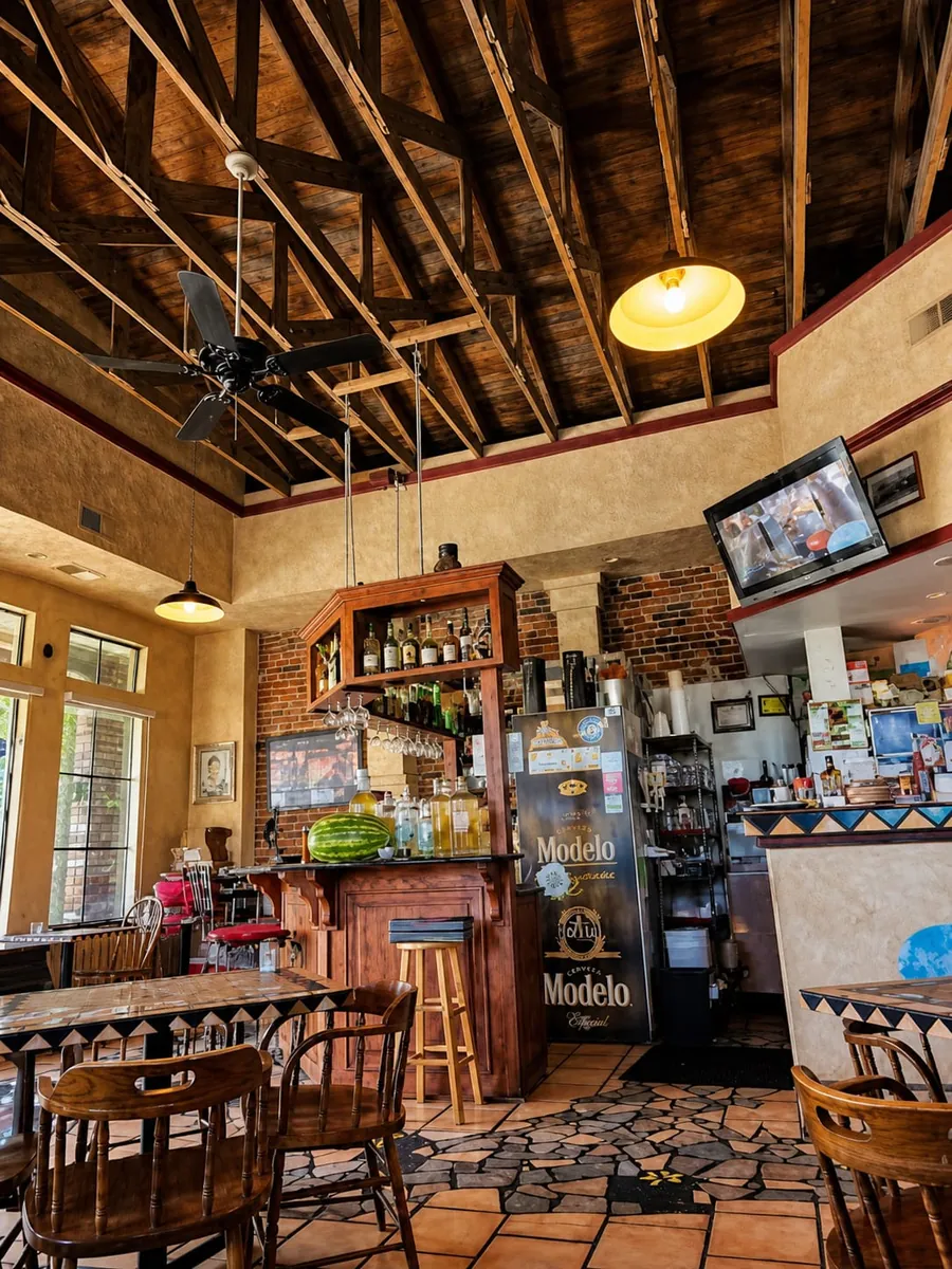 The dining room with wood-truss ceilings and tiled tables